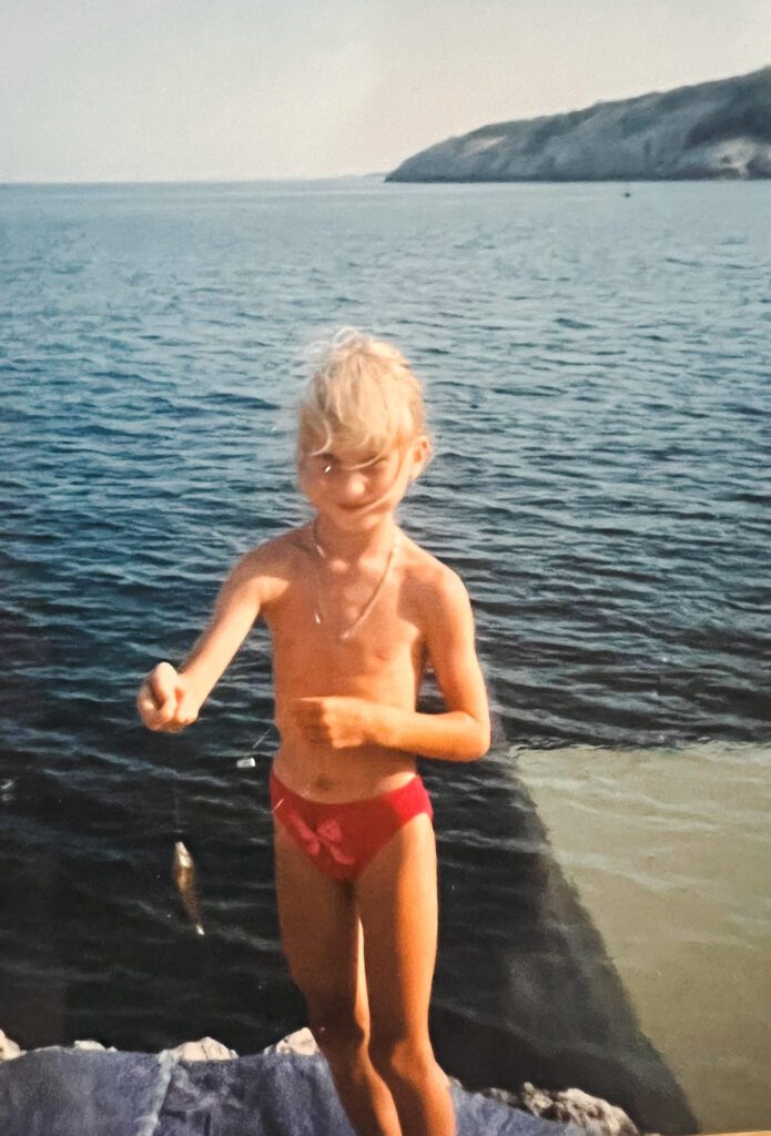 Younger Anja on Adventure catching fish on a Croatian coast