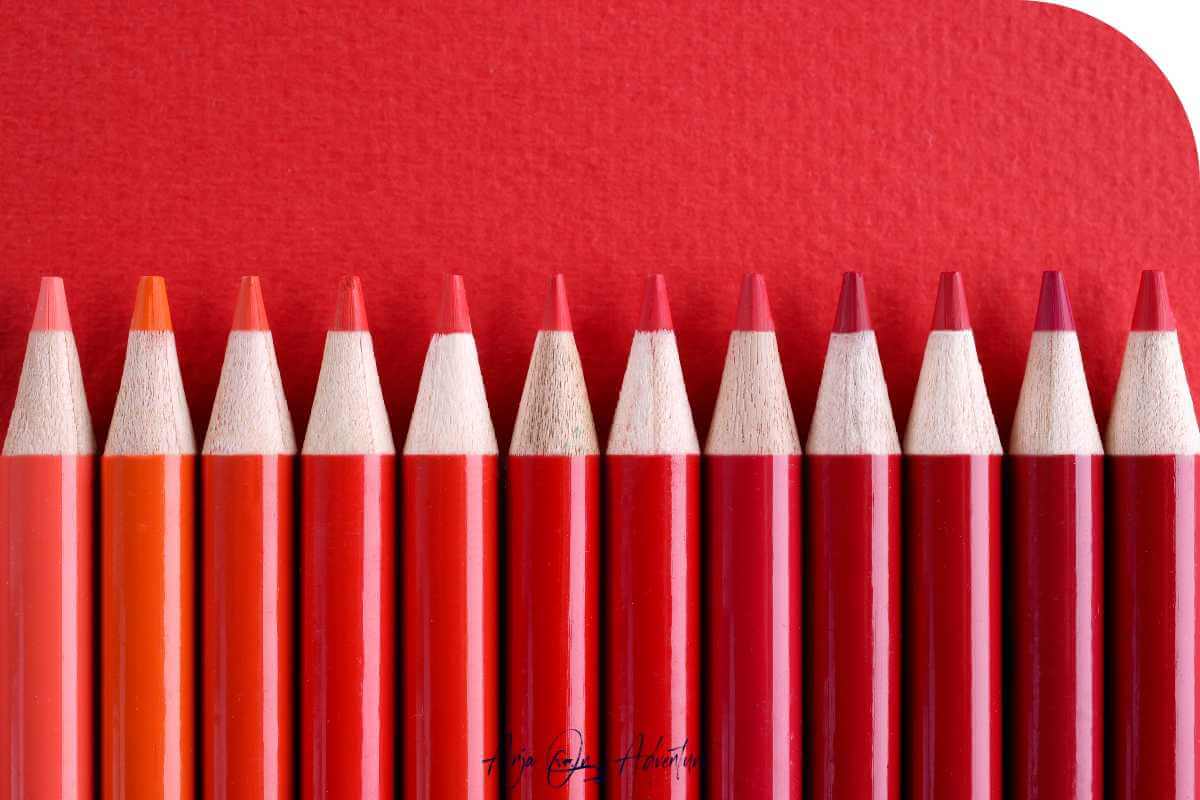 Coloring pencils in the shades of red to match with red travel destinations